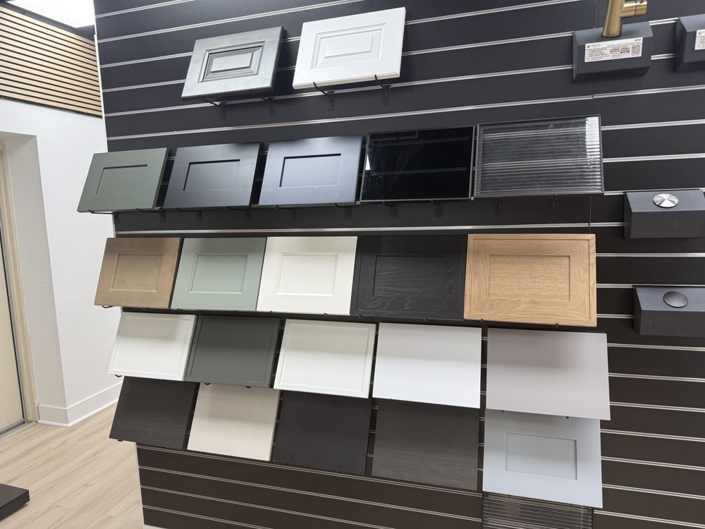 Wall of cabinet door styles and finishes on display in the showroom