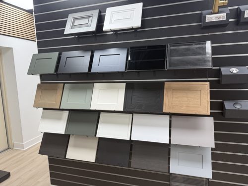 Cabinet door styles and finishes displayed on a dark slatwall