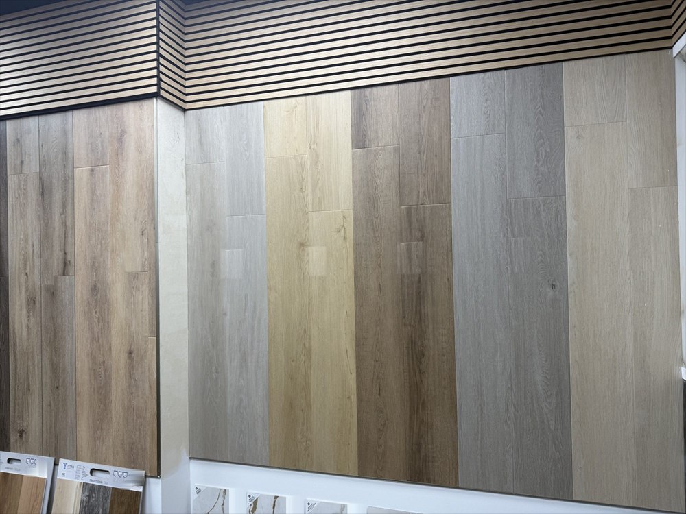 Neutral-toned plank flooring samples on a display wall