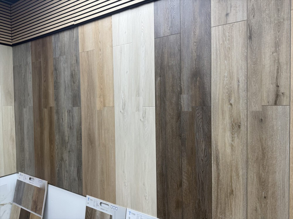 Wood-look plank flooring samples on a showroom display wall