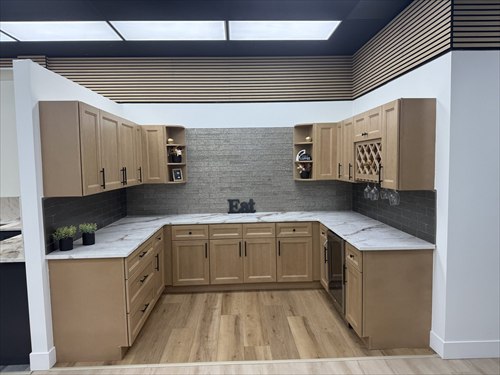 Light wood cabinets with a grey backsplash