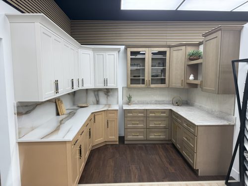 White and light wood cabinets with a waterfall marble island